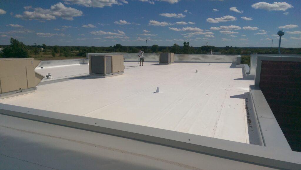 Worker on flat commercial roof